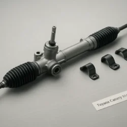 Rack and pinion steering assembly and components arranged on a workbench with a small label indicating Toyota Camry fitment.