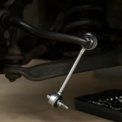 Toyota Camry front suspension with a newly installed sway bar link and visible mounting hardware